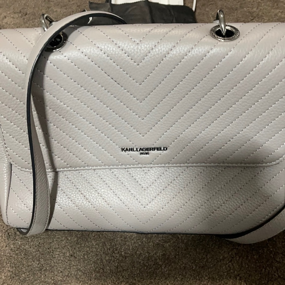 New. Karlla Gerfeld. Grayish color envelope hand bag/ crossbody.
